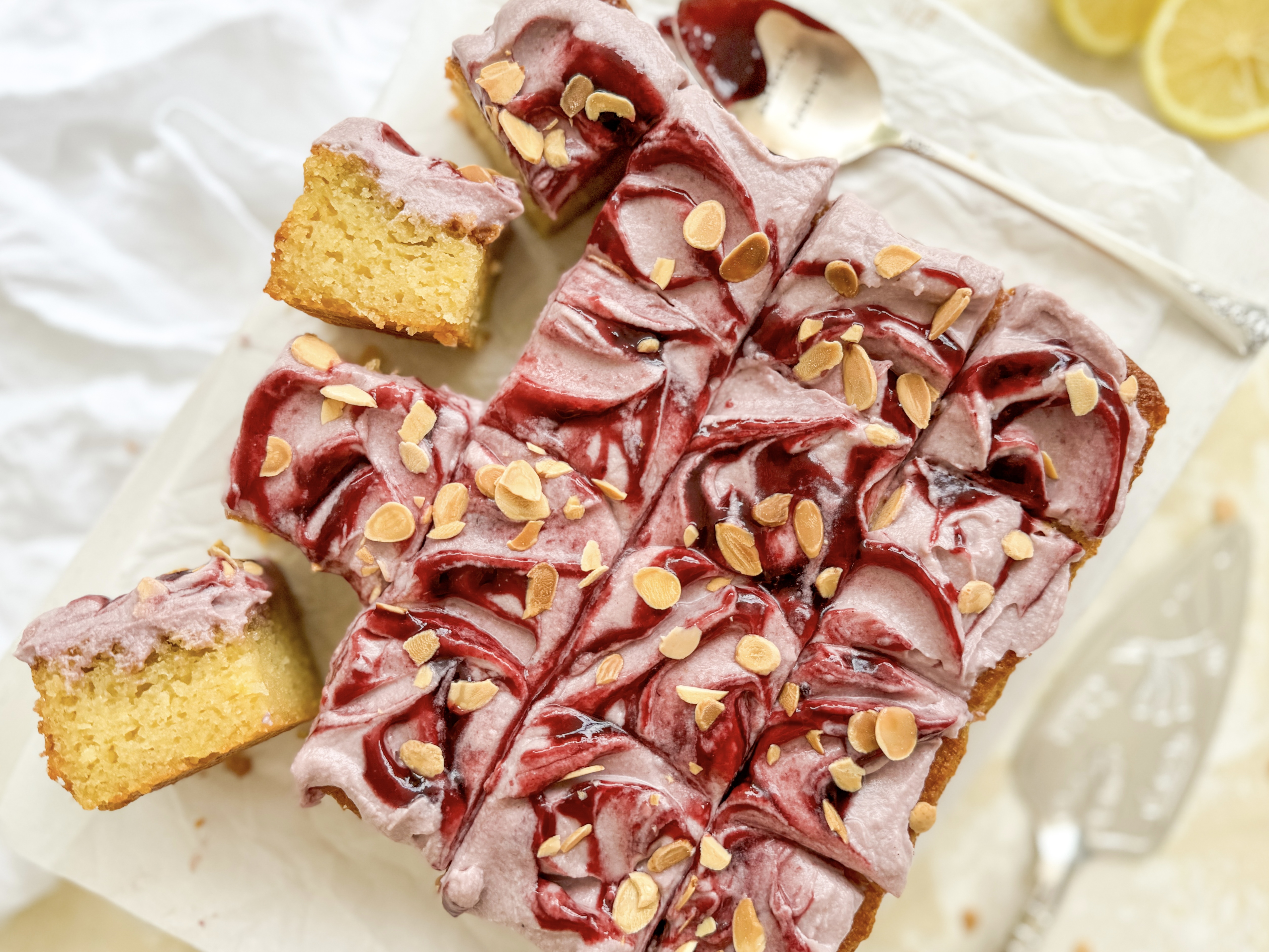 Photograph of Lemon and Almond Olive Oil Slice with Blackberry Mascarpone Frosting